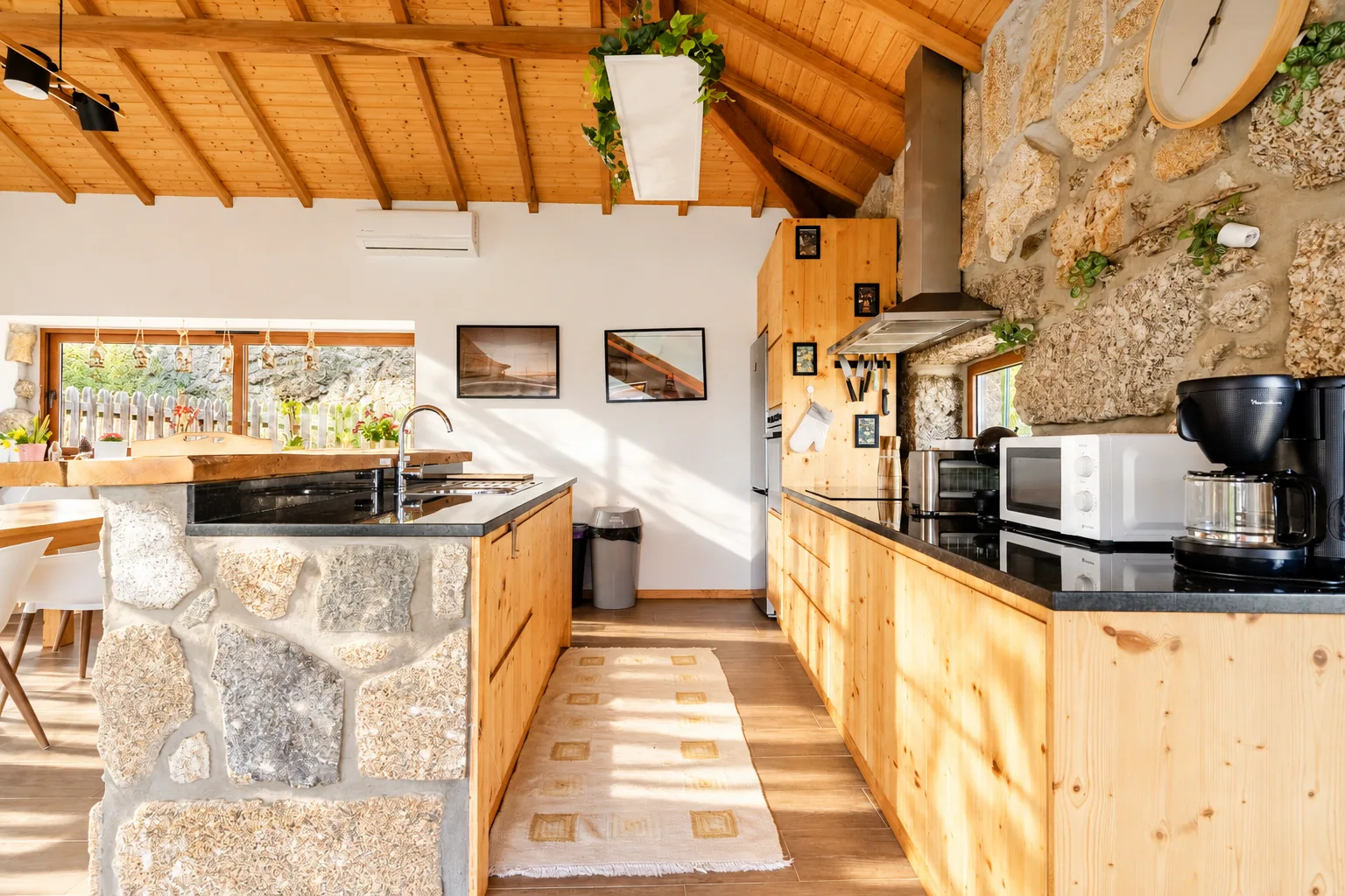 Kitchen at Casa do Sol with wooden cabinets and a stone island